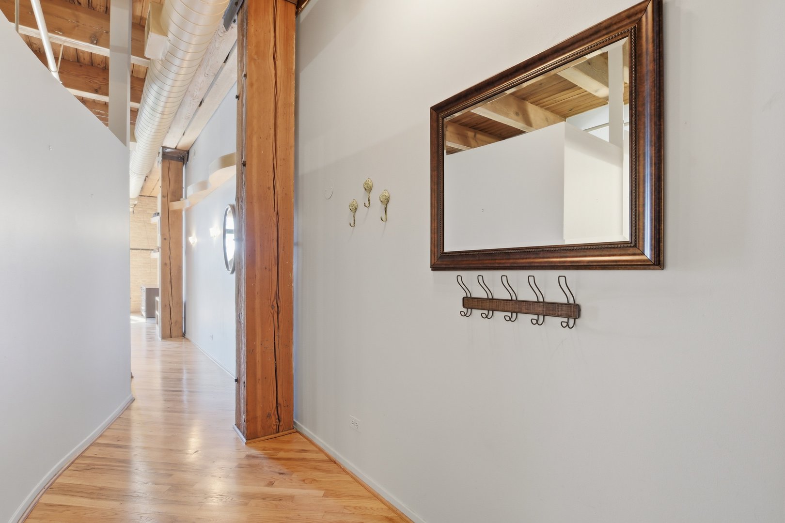 1250 West Van Buren Street, Unit 313 Chicago, IL 60607 - Photo 2 of 16 a view of a hallway with wooden floor and entryway