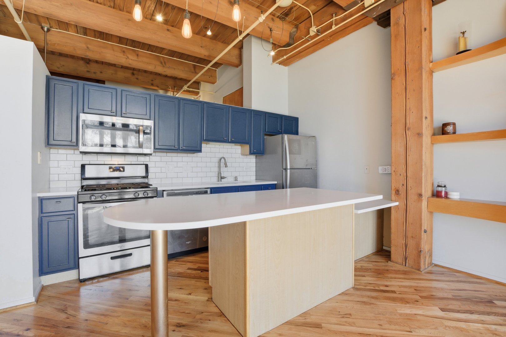 1250 West Van Buren Street, Unit 313 Chicago, IL 60607 - Photo 4 of 16 a kitchen with stainless steel appliances a sink and a refrigerator