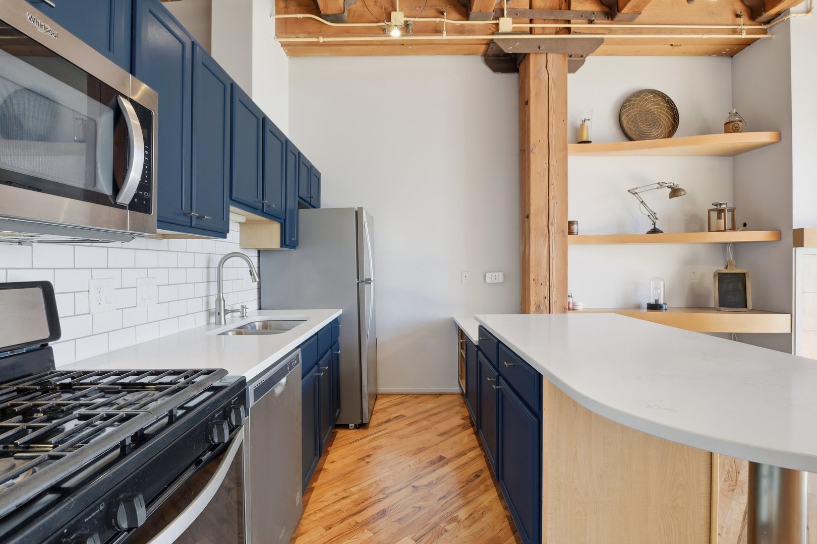 1250 West Van Buren Street, Unit 313 Chicago, IL 60607 - Photo 5 of 16 a kitchen with a stove and a sink