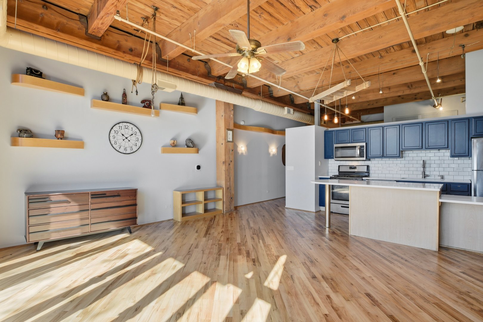 1250 West Van Buren Street, Unit 313 Chicago, IL 60607 - Photo 7 of 16 a view of kitchen with cabinets and wooden floor