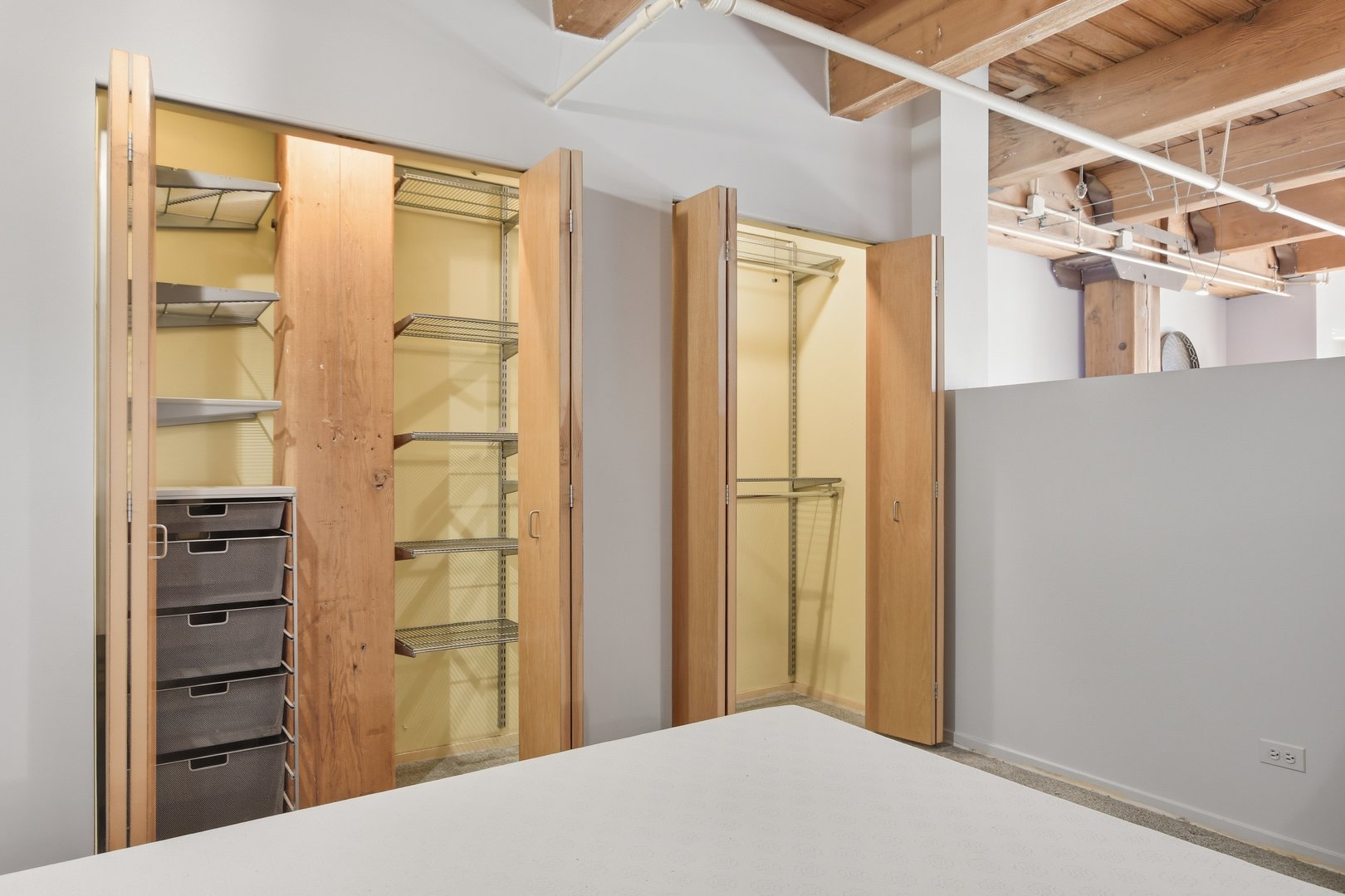 1250 West Van Buren Street, Unit 313 Chicago, IL 60607 - Photo 9 of 16 a bedroom with a bed and a cabinet