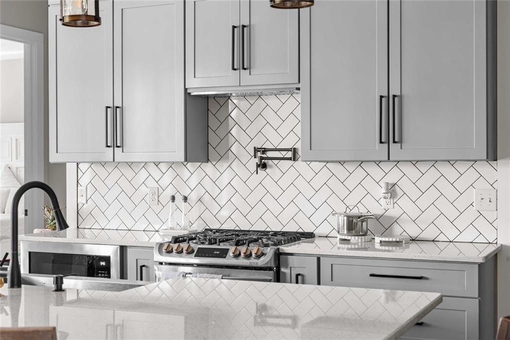 5758 Williams Road Norcross, GA 30093 - Photo 20 of 90 a kitchen with stainless steel appliances kitchen island a stove and a sink