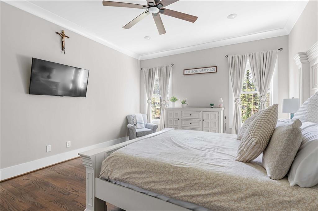 5758 Williams Road Norcross, GA 30093 - Photo 24 of 90 a bedroom with a bed and a flat screen tv