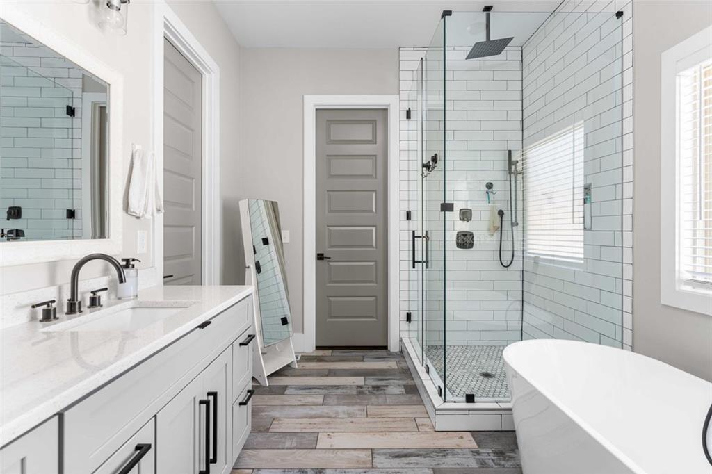 5758 Williams Road Norcross, GA 30093 - Photo 25 of 90 a bathroom with a sink a toilet a tub and shower
