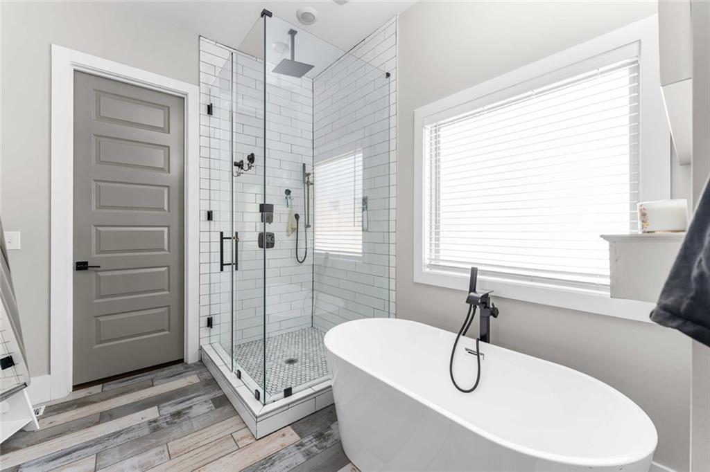 5758 Williams Road Norcross, GA 30093 - Photo 28 of 90 a bathroom with a tub and a shower