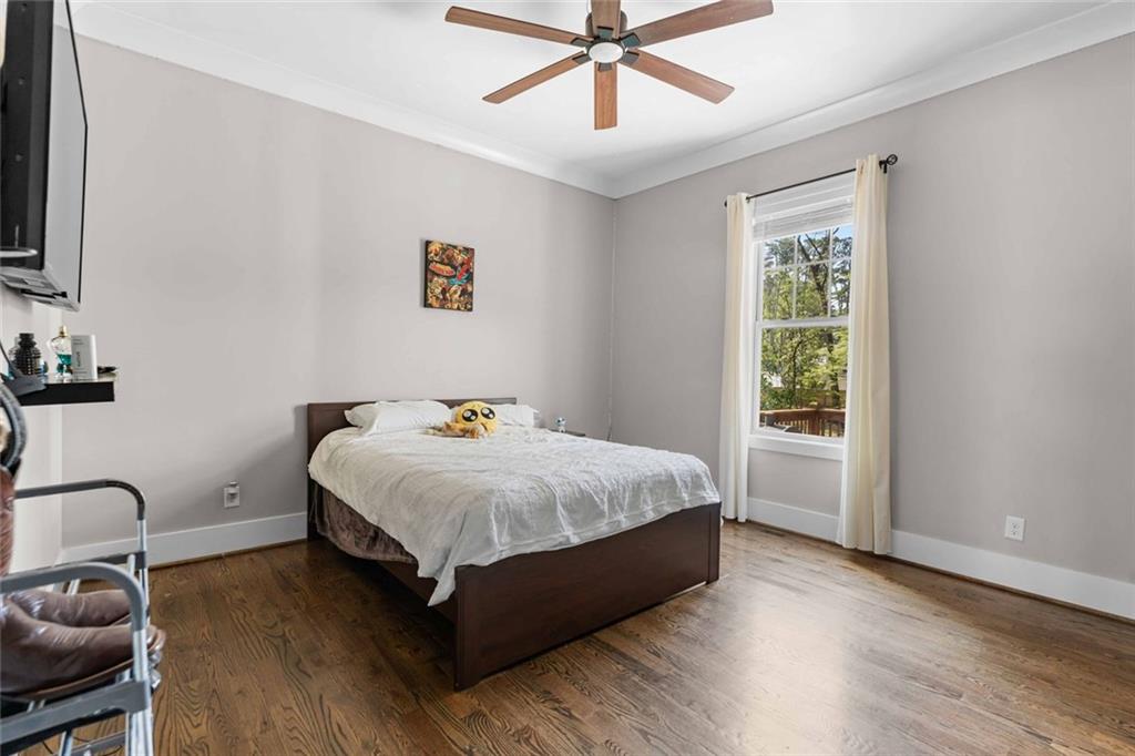 5758 Williams Road Norcross, GA 30093 - Photo 32 of 90 a spacious bedroom with a bed and window