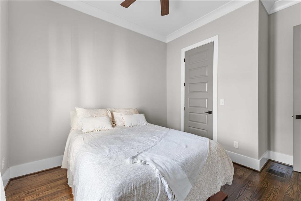 5758 Williams Road Norcross, GA 30093 - Photo 34 of 90 a bedroom with a bed and a potted plant