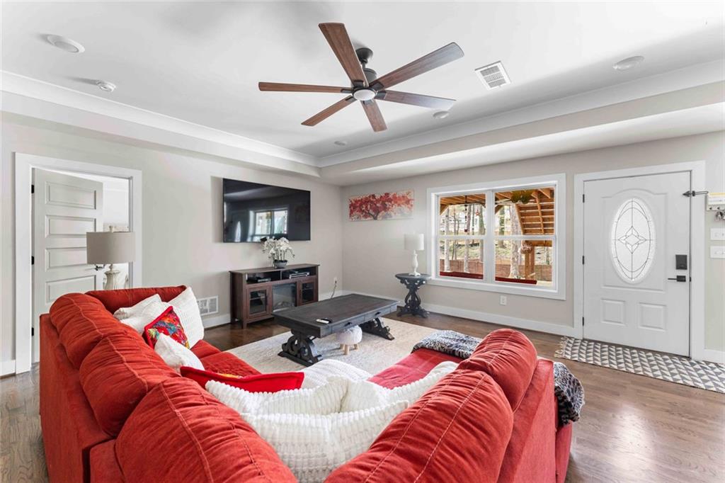 5758 Williams Road Norcross, GA 30093 - Photo 40 of 90 a living room with furniture a ceiling fan and a large window