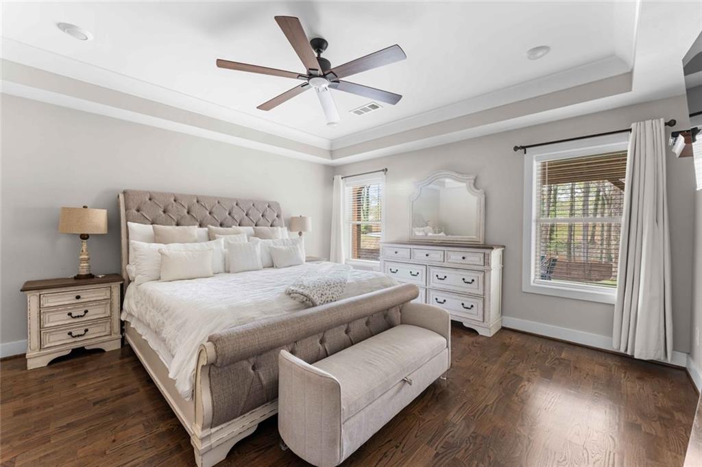 5758 Williams Road Norcross, GA 30093 - Photo 49 of 90 a bedroom with a large bed and wooden floor