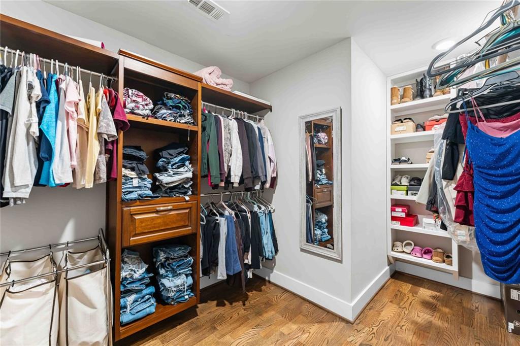 5758 Williams Road Norcross, GA 30093 - Photo 55 of 90 a view of walk in closet with clothes and shoes