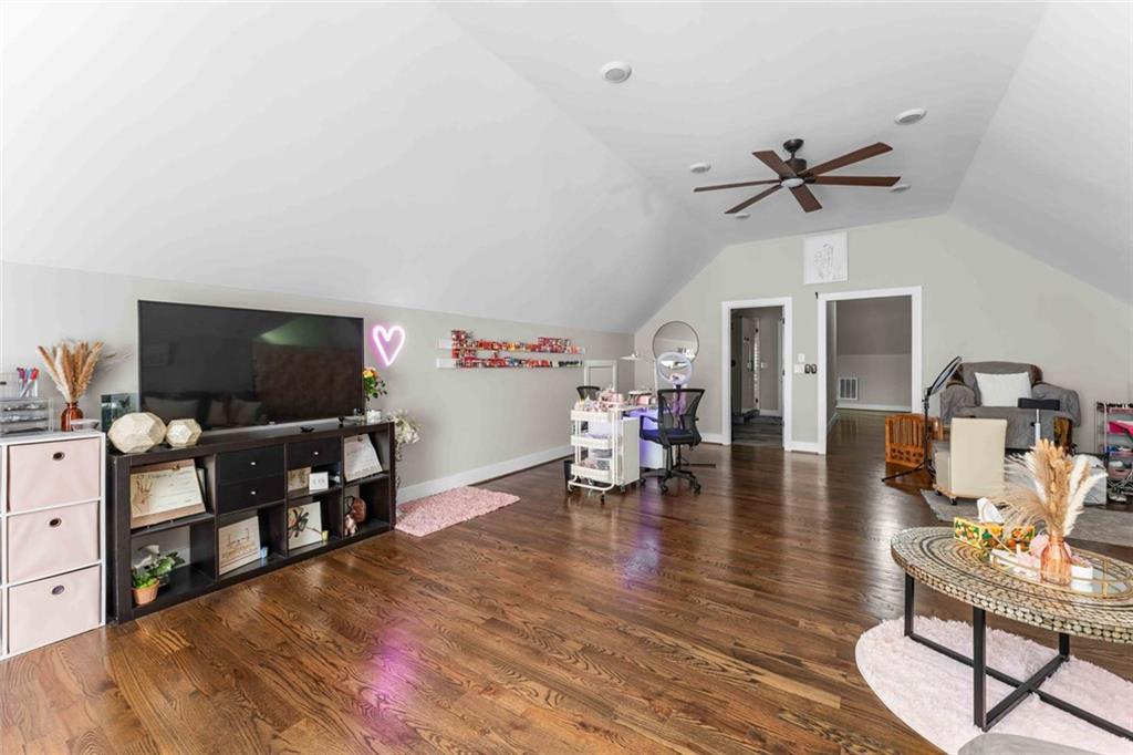 5758 Williams Road Norcross, GA 30093 - Photo 64 of 90 a living room with furniture and a flat screen tv