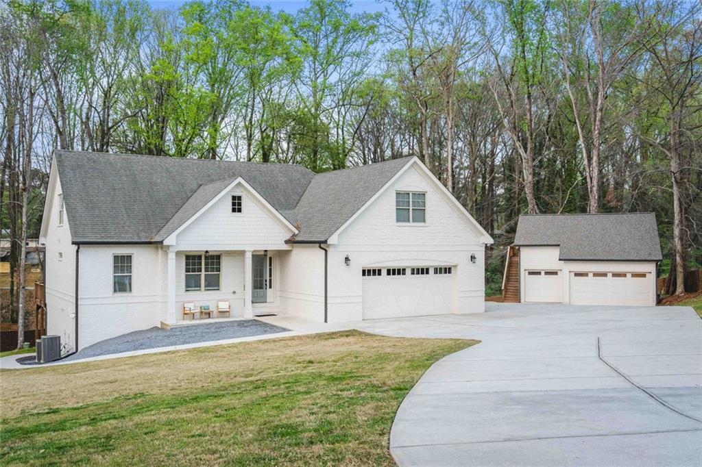 5758 Williams Road Norcross, GA 30093 - Photo 81 of 90 a front view of a house with a yard and trees