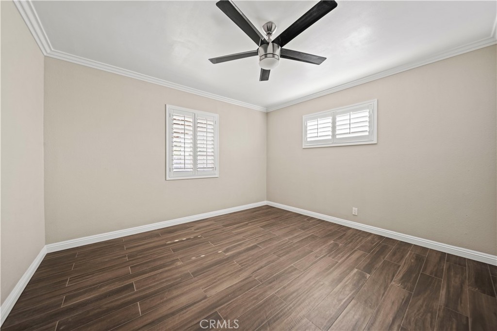 14559 Ector Street La Puente, CA 91744 - Photo 17 of 29 an empty room with wooden floor ceiling fan and windows