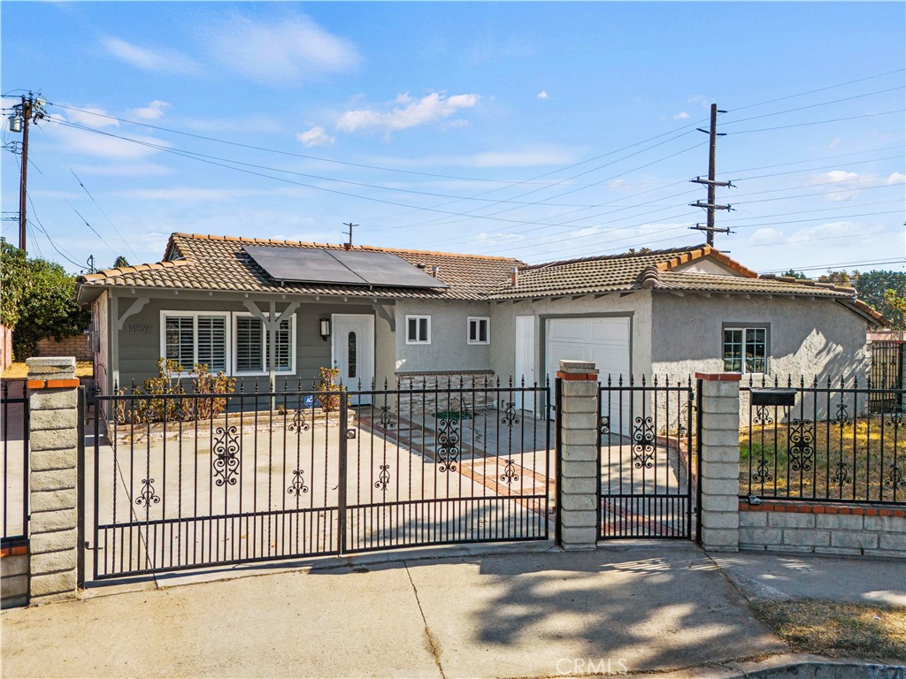 14559 Ector Street La Puente, CA 91744 - Photo 2 of 29 a front view of a house with a iron gate