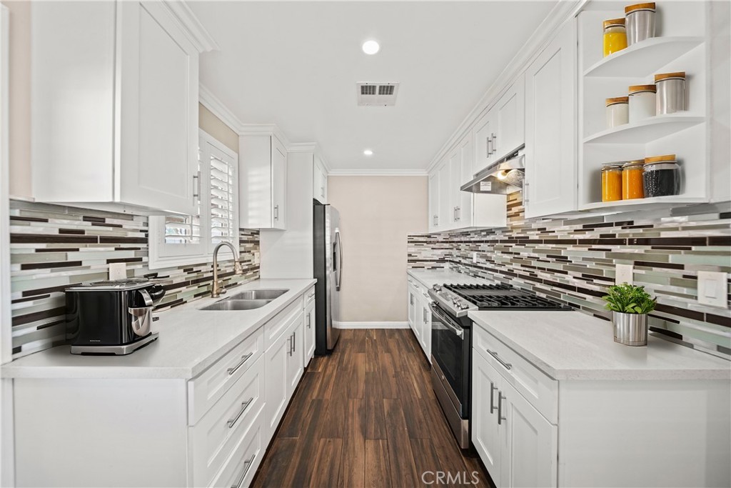 14559 Ector Street La Puente, CA 91744 - Photo 7 of 29 a kitchen with a stove a sink and a refrigerator
