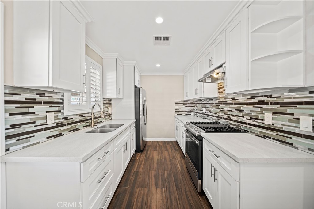 14559 Ector Street La Puente, CA 91744 - Photo 8 of 29 a kitchen with a stove a sink and a refrigerator