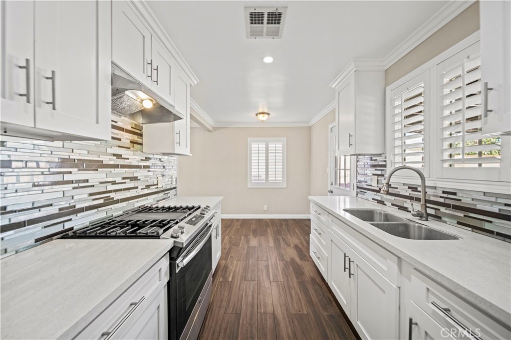 14559 Ector Street La Puente, CA 91744 - Photo 9 of 29 a kitchen with sink a stove and cabinets