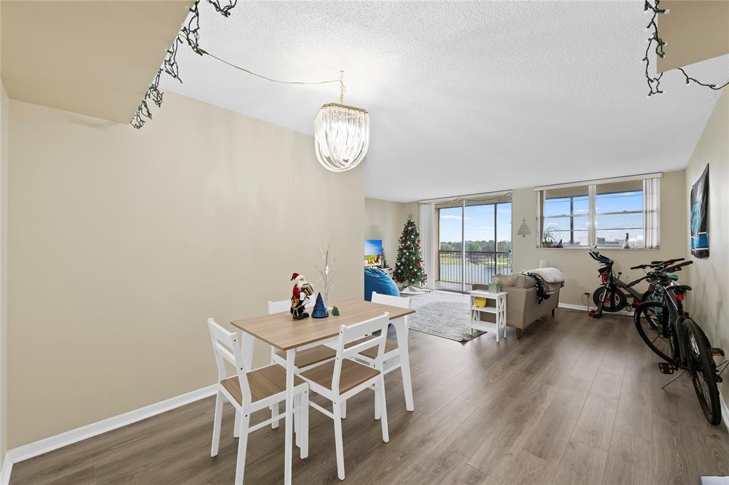 3150 West Rolling Hills Circle, Unit 603 Davie, FL 33328 - Photo 4 of 23 a view of a dining room with furniture wooden floor and a rug