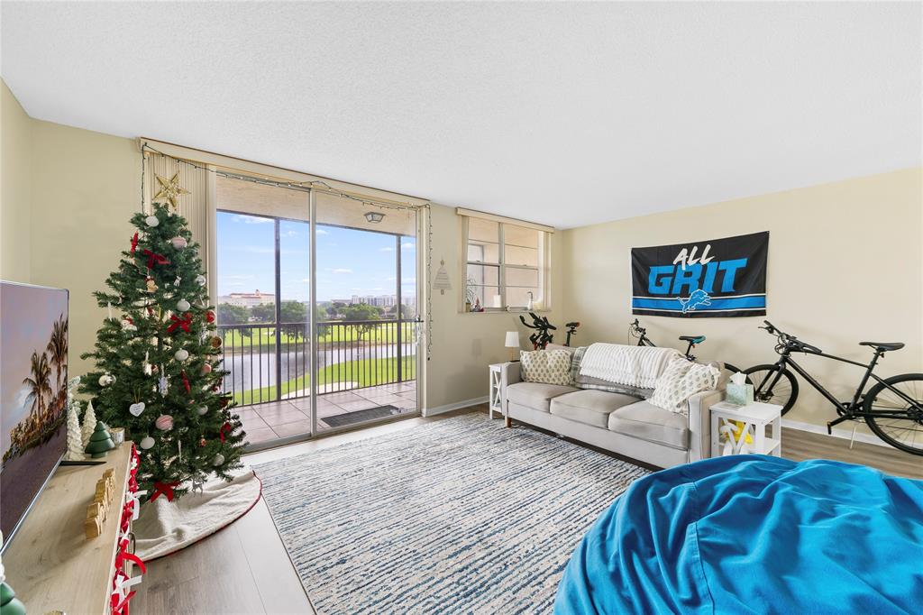 3150 West Rolling Hills Circle, Unit 603 Davie, FL 33328 - Photo 5 of 23 a living room with furniture floor to ceiling window and a potted plant