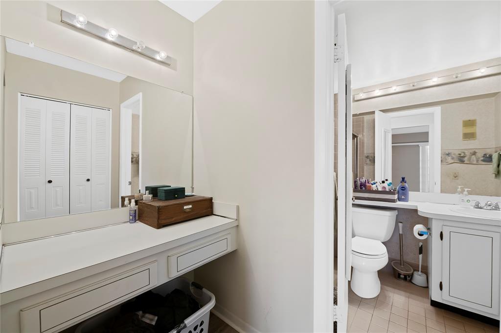 3150 West Rolling Hills Circle, Unit 603 Davie, FL 33328 - Photo 9 of 23 a bathroom with a sink a toilet and a mirror