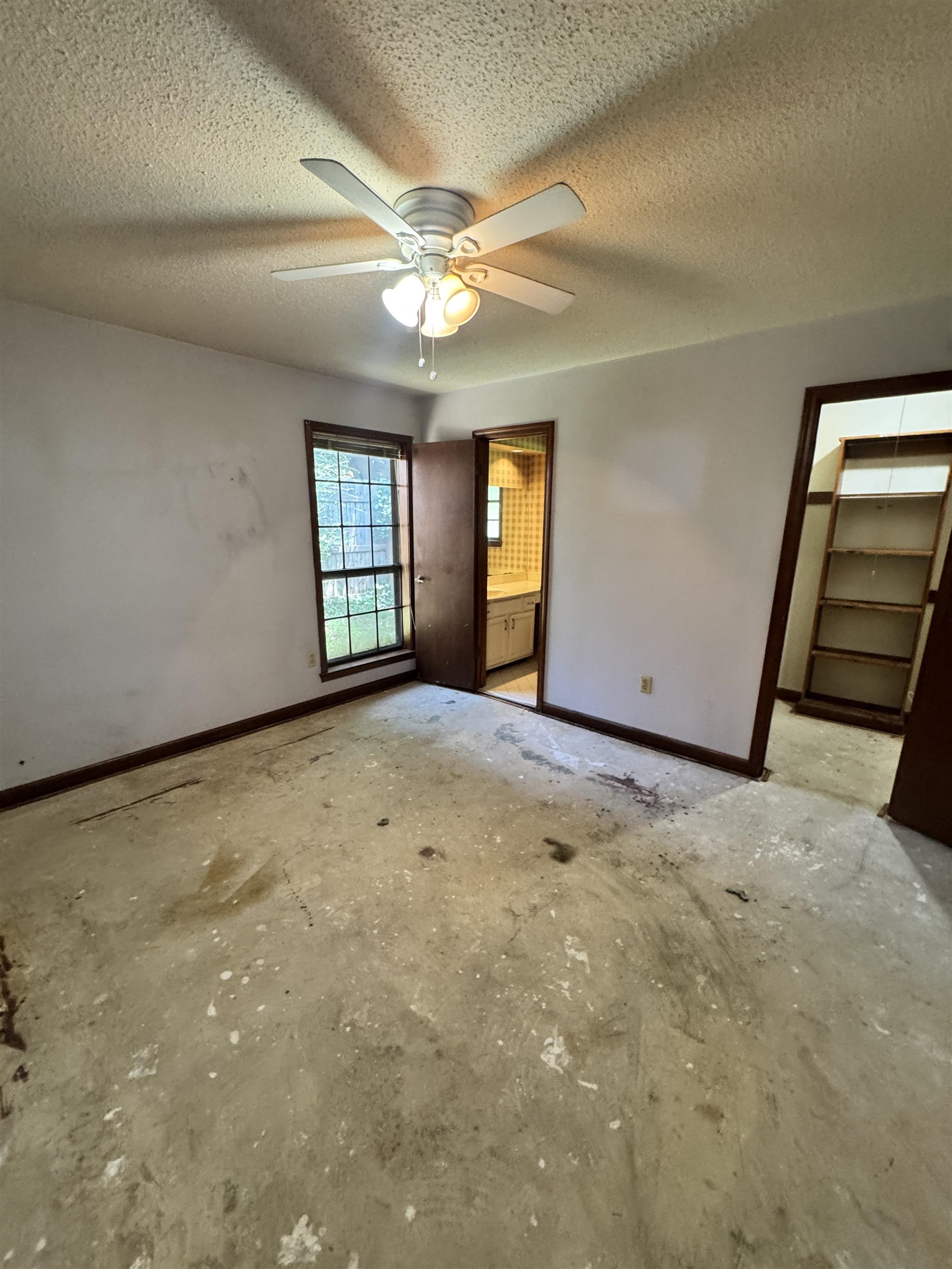 4334 Timber Rise Road Memphis, TN 38125 - Photo 11 of 18 Interior room featuring a window, overhead fan with lighting, and an entryway to another space with built-in shelving