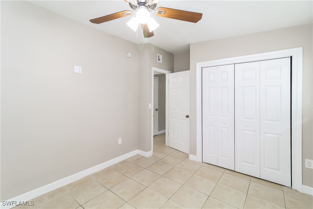 315 Ginger Road Venice, FL 34293 - Photo 11 of 16 an empty room with closet and a chandelier fan