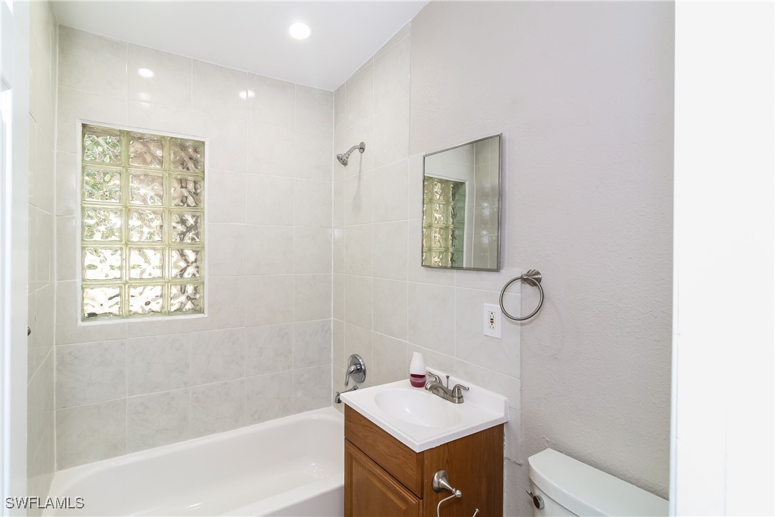 315 Ginger Road Venice, FL 34293 - Photo 14 of 16 a bathroom with a sink mirror toilet and vanity