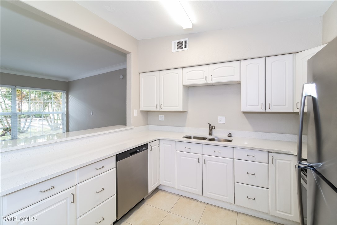 315 Ginger Road Venice, FL 34293 - Photo 7 of 16 a kitchen with white cabinets and white appliances
