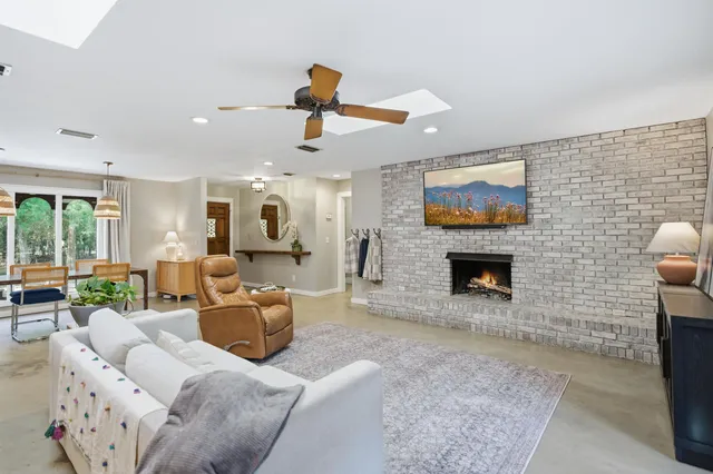 a living room with furniture and a ceiling fan