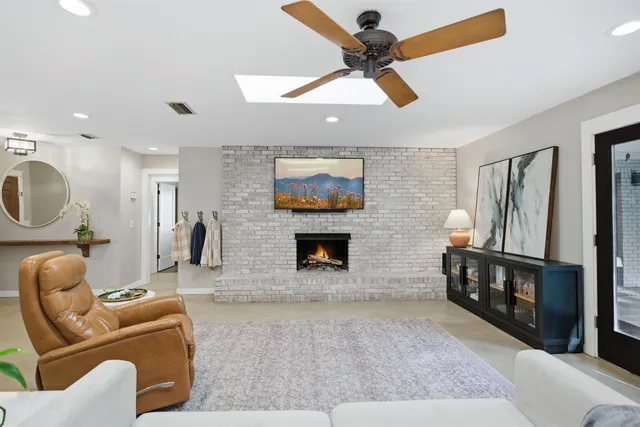 a view of a livingroom with furniture and a window