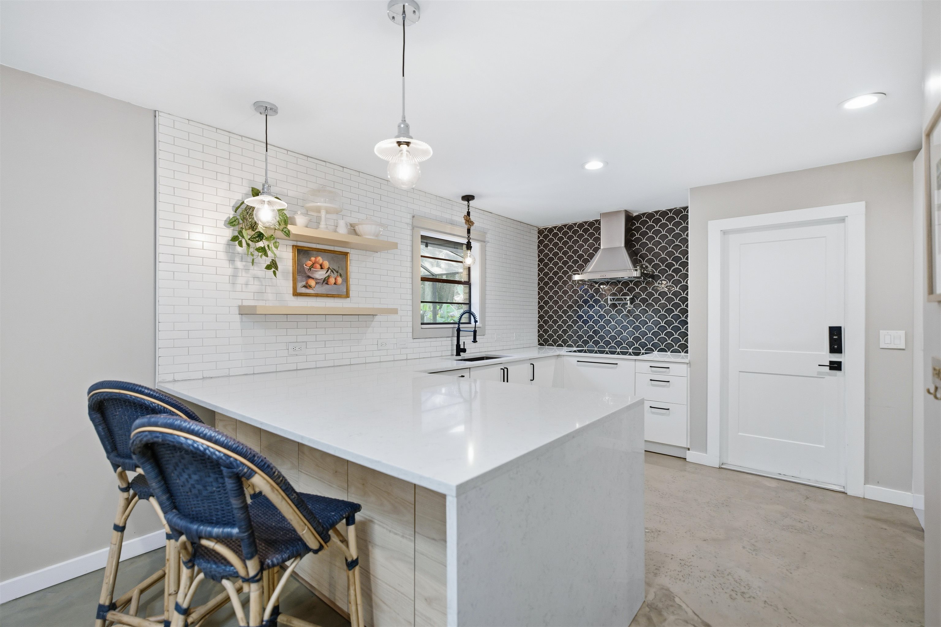 3572 Red Cloud Trail St. Augustine, FL 32086 - Photo 18 of 74 Kitchen featuring open shelves, a peninsula, a kitchen bar, concrete flooring, and recessed lighting