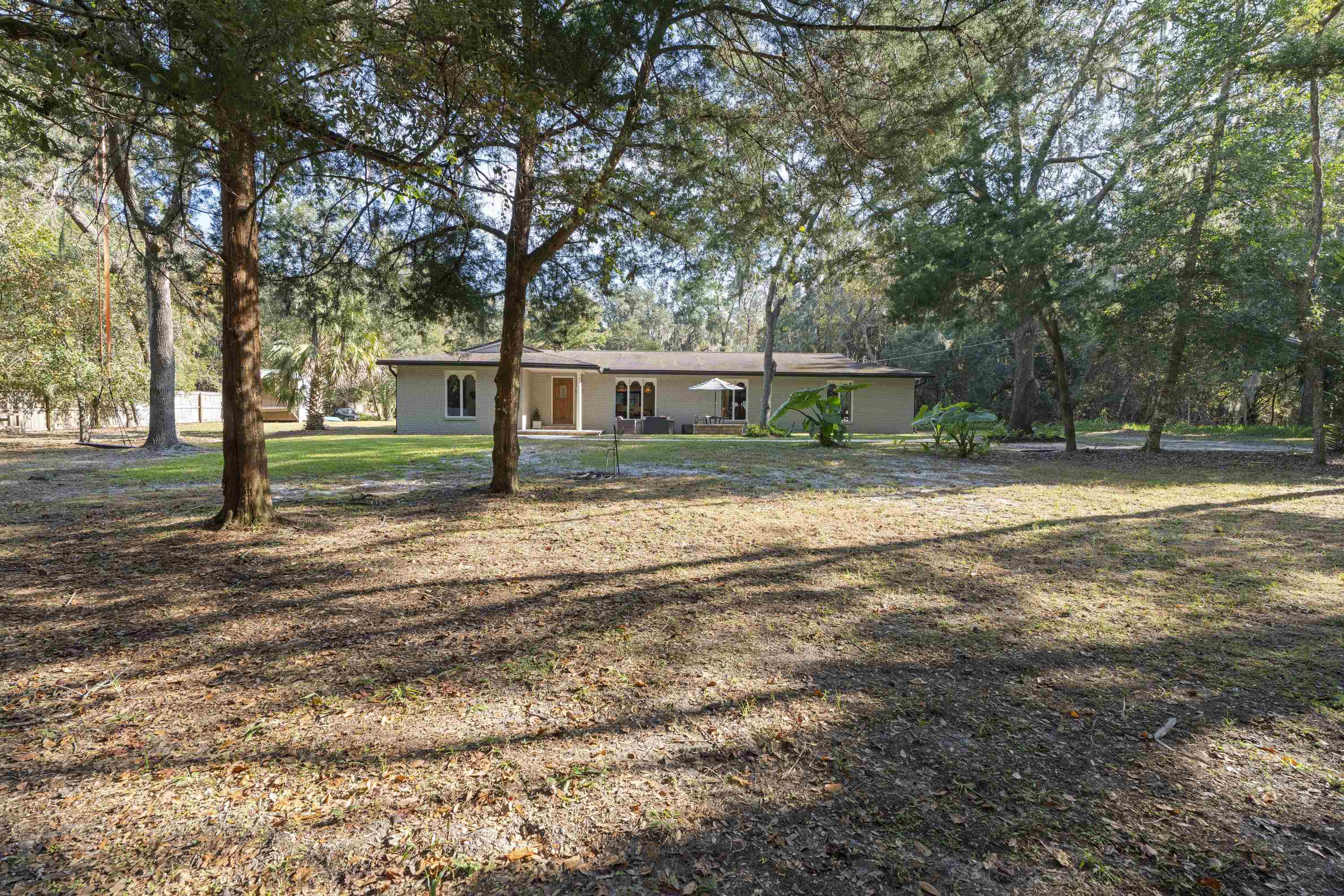 3572 Red Cloud Trail St. Augustine, FL 32086 - Photo 2 of 74 Ranch-style house with a front yard and view of scattered trees