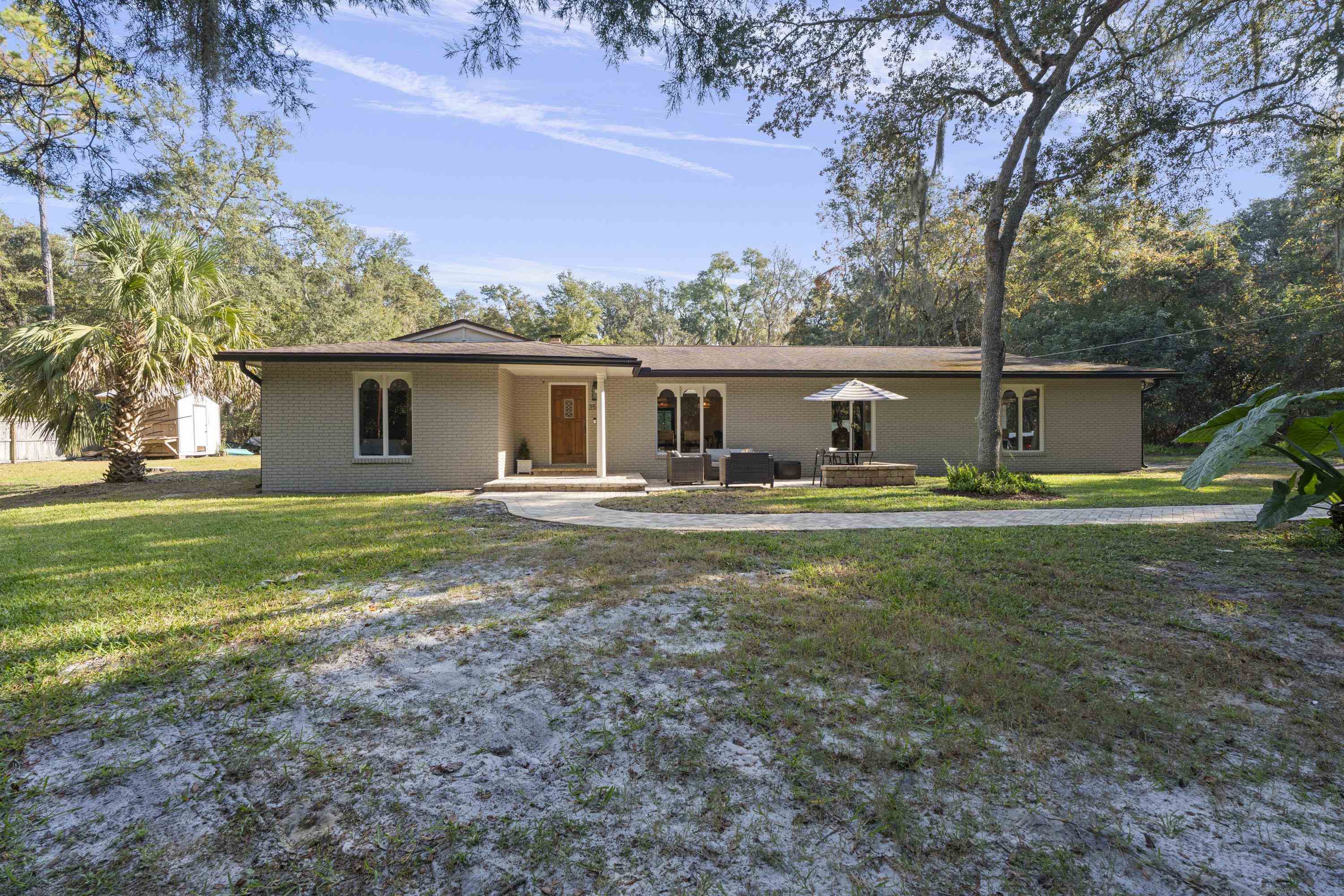 3572 Red Cloud Trail St. Augustine, FL 32086 - Photo 3 of 74 Ranch-style house featuring covered porch, a front lawn, and brick siding