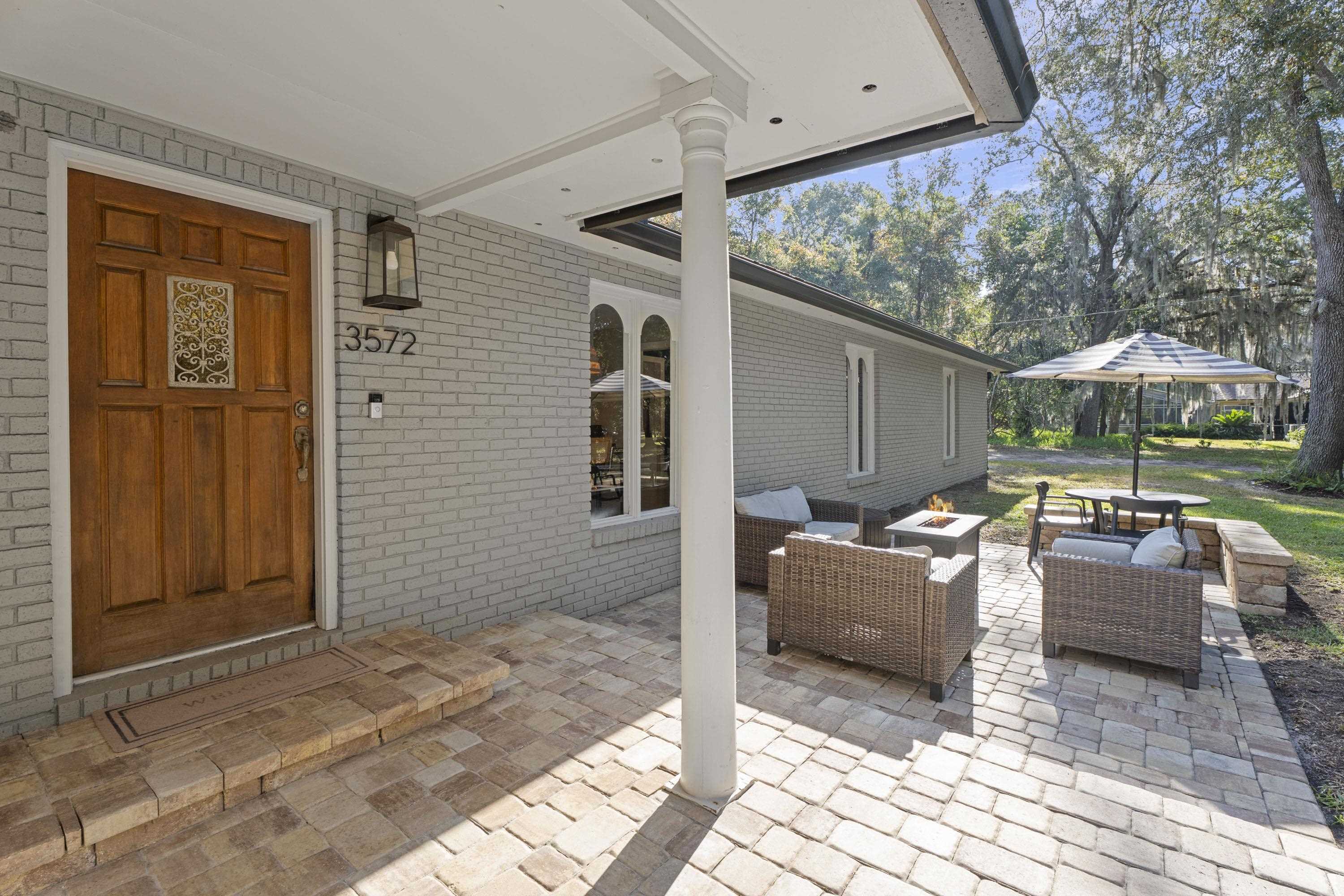3572 Red Cloud Trail St. Augustine, FL 32086 - Photo 4 of 74 a backyard of a house with sofas fire pit and outdoor seating