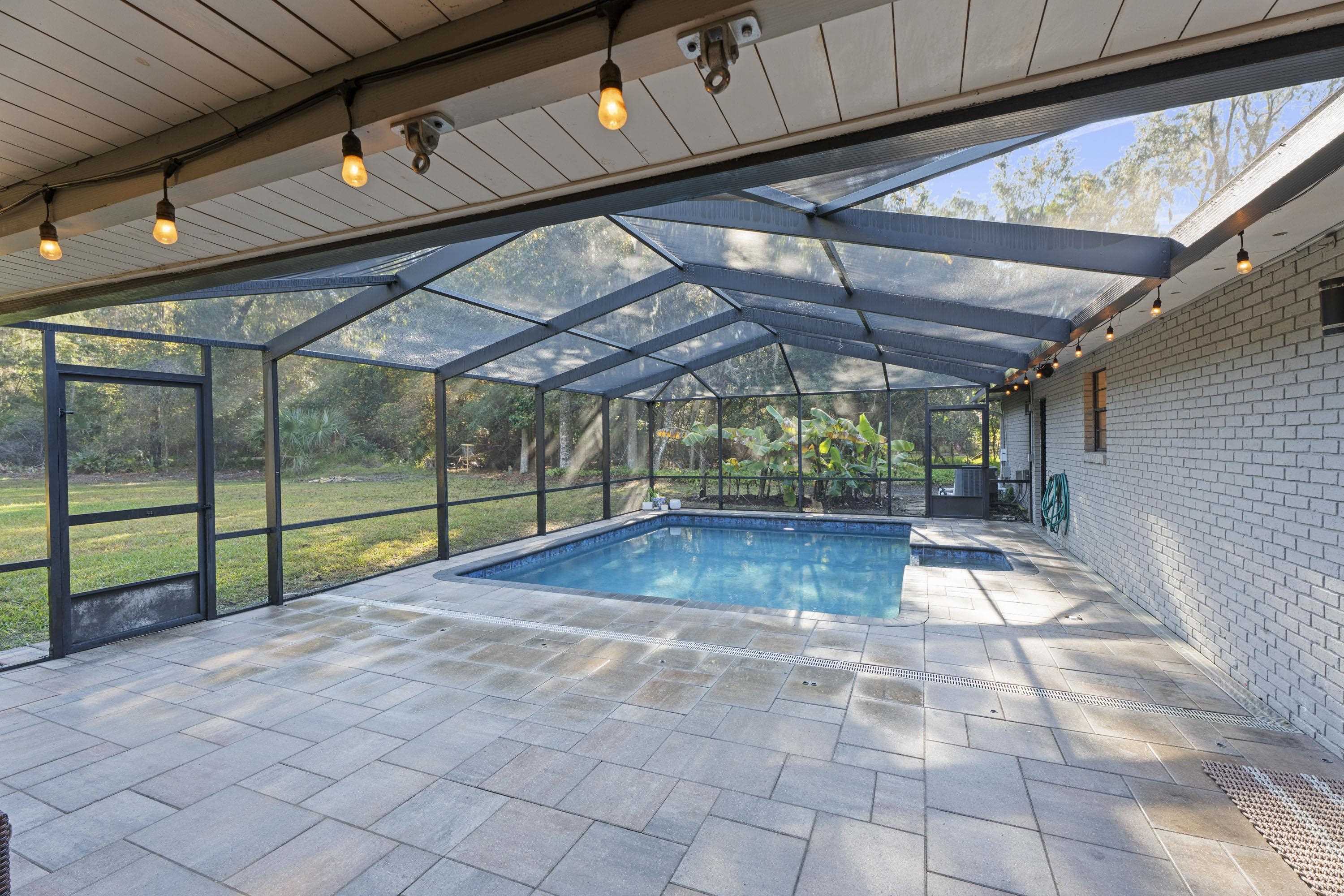 3572 Red Cloud Trail St. Augustine, FL 32086 - Photo 41 of 74 Outdoor pool featuring a lanai, a patio, and a sunroom