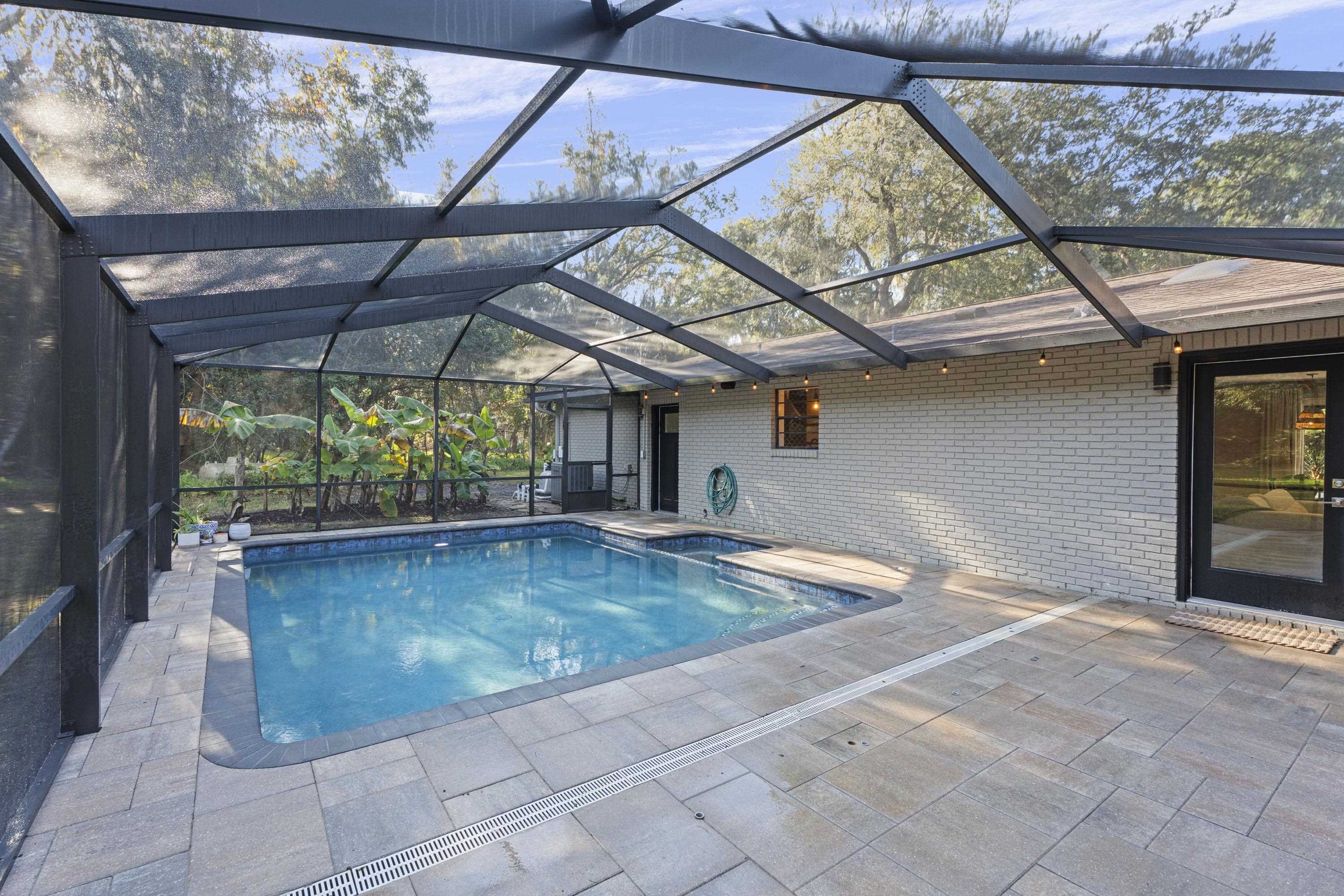 3572 Red Cloud Trail St. Augustine, FL 32086 - Photo 42 of 74 Swimming pool featuring glass enclosure, a patio area, and a sunroom