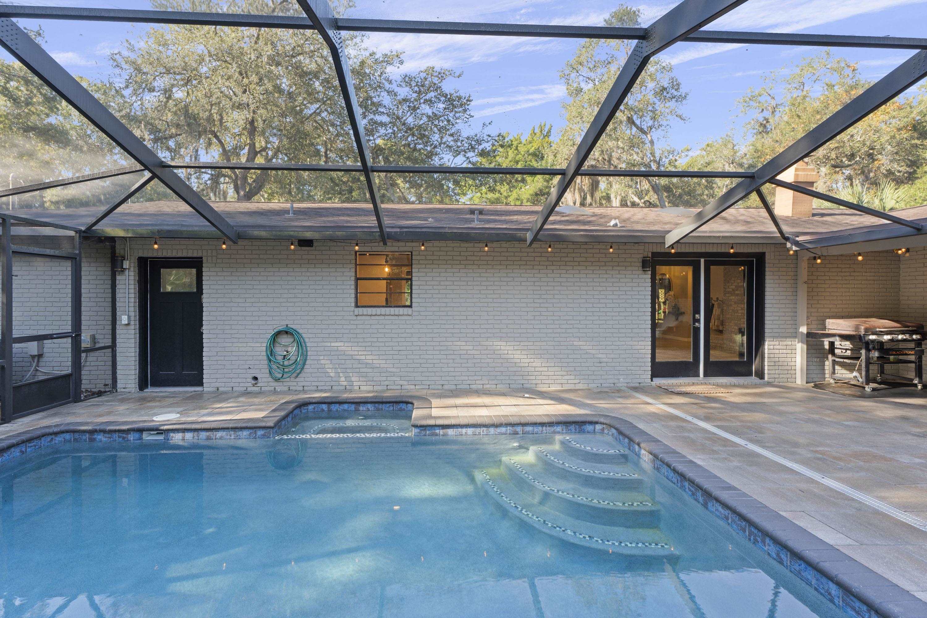 3572 Red Cloud Trail St. Augustine, FL 32086 - Photo 43 of 74 Outdoor pool with a sunroom, glass enclosure, and a patio area