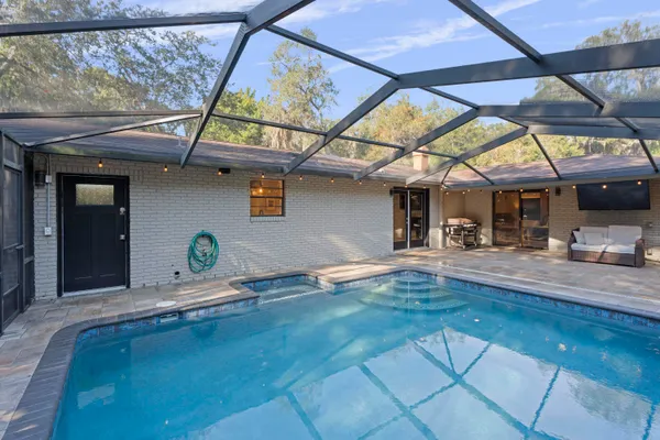 an aerial view of a house with yard swimming pool and outdoor seating