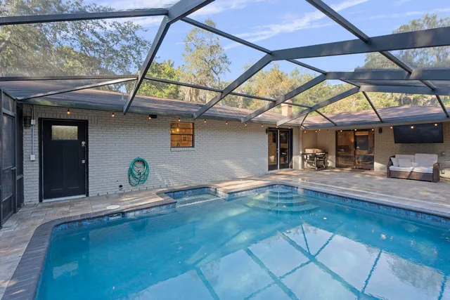 an aerial view of a house with yard swimming pool and outdoor seating