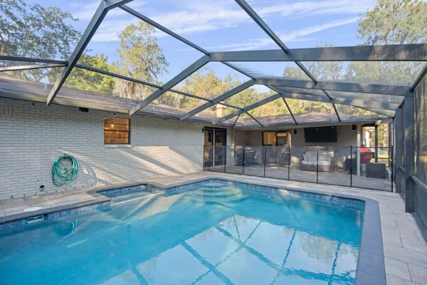 an aerial view of a house with yard swimming pool and outdoor seating