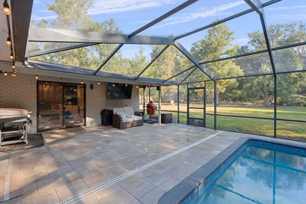 a view of a swimming pool and trees in the background