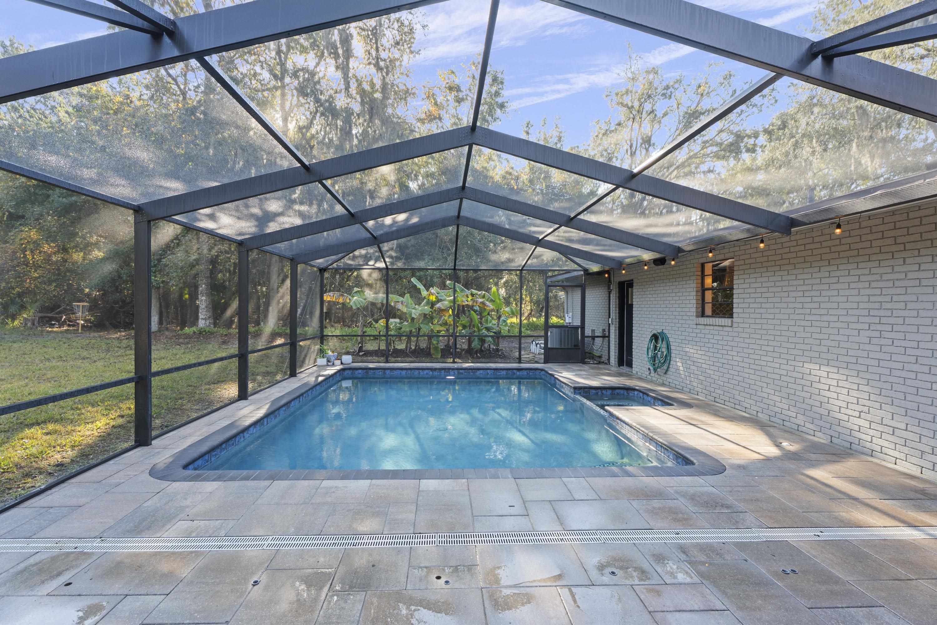 3572 Red Cloud Trail St. Augustine, FL 32086 - Photo 50 of 74 Swimming pool featuring a sunroom, glass enclosure, an in-ground hot tub, and a patio