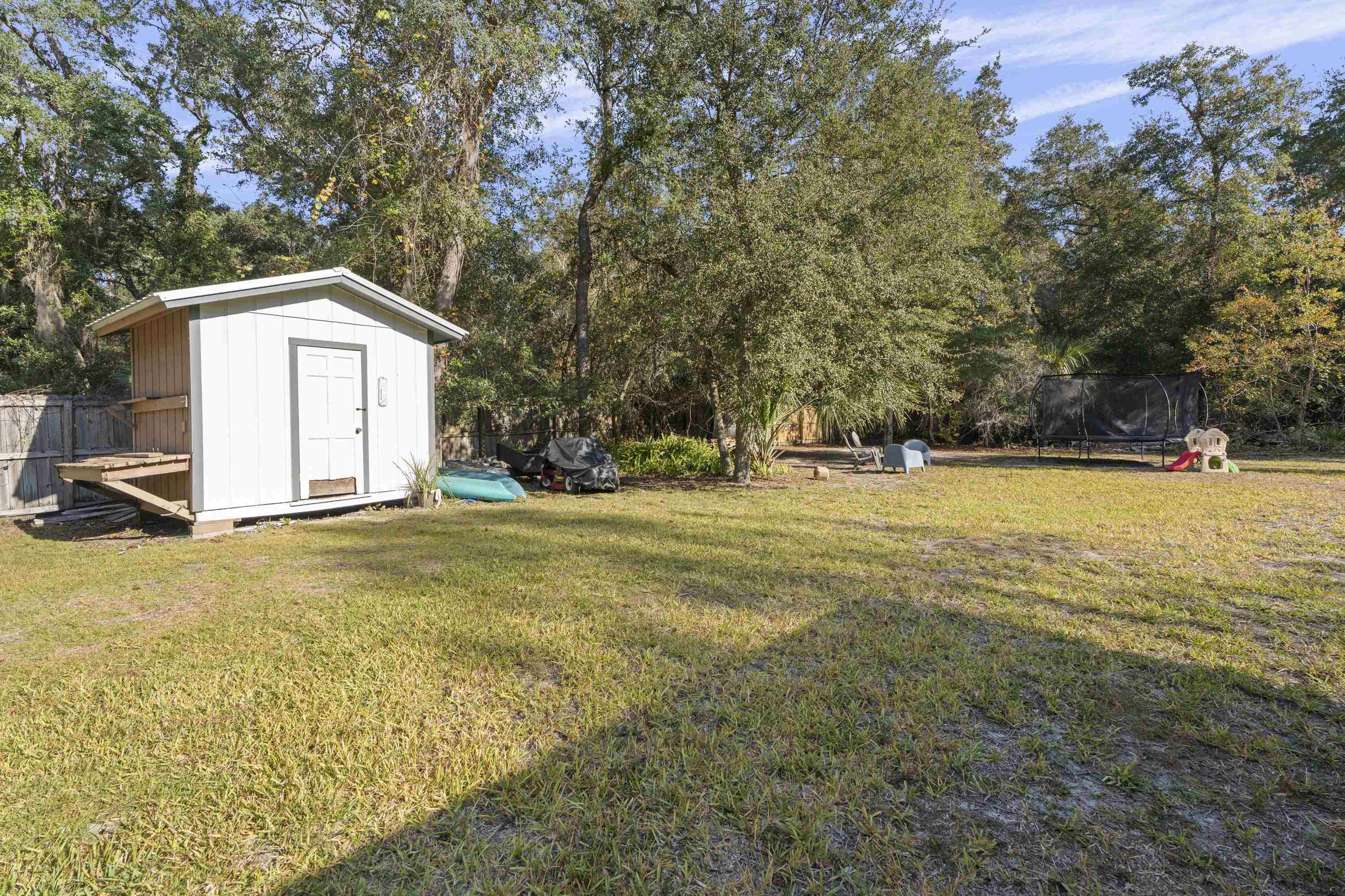 3572 Red Cloud Trail St. Augustine, FL 32086 - Photo 54 of 74 a view of a tree in front of a house with a yard