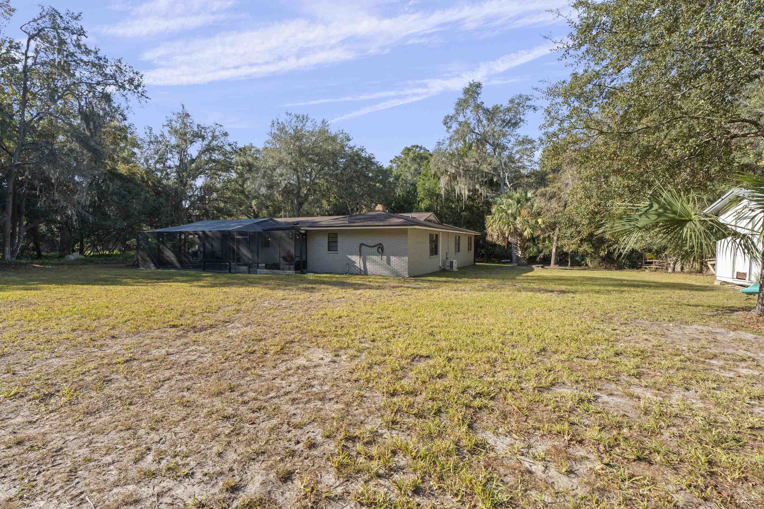 3572 Red Cloud Trail St. Augustine, FL 32086 - Photo 55 of 74 Back of property featuring a lawn, glass enclosure, and a sunroom