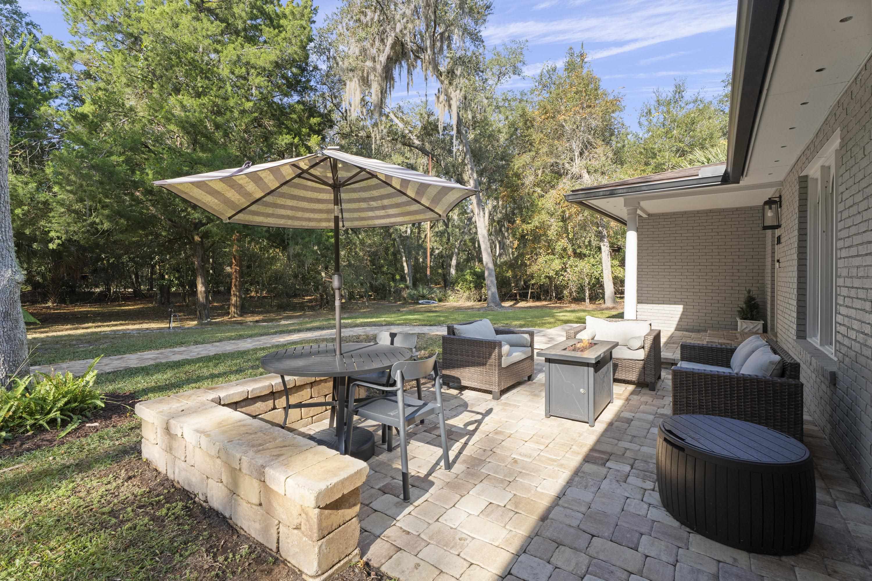 3572 Red Cloud Trail St. Augustine, FL 32086 - Photo 60 of 74 a view of a patio with couches table and chairs and potted plants