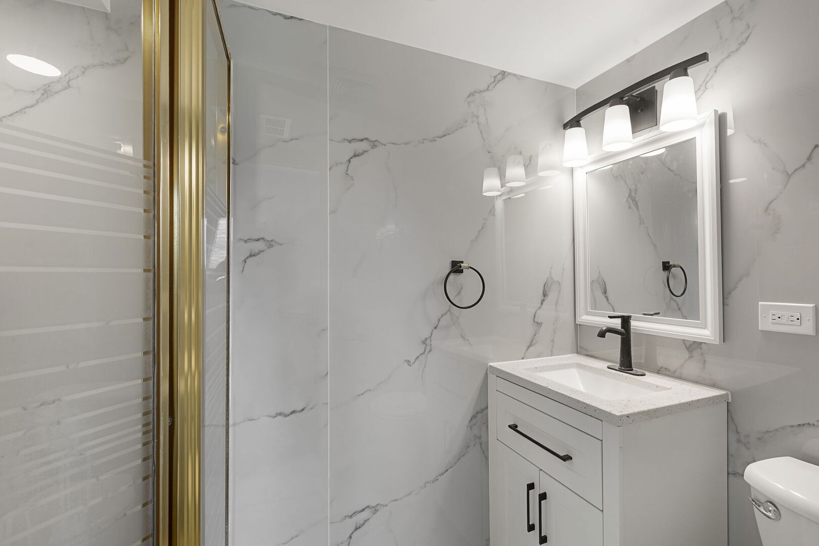 1910 Ashley Road Hoffman Estates, IL 60169 - Photo 12 of 30 a bathroom with a granite countertop sink a mirror and shower