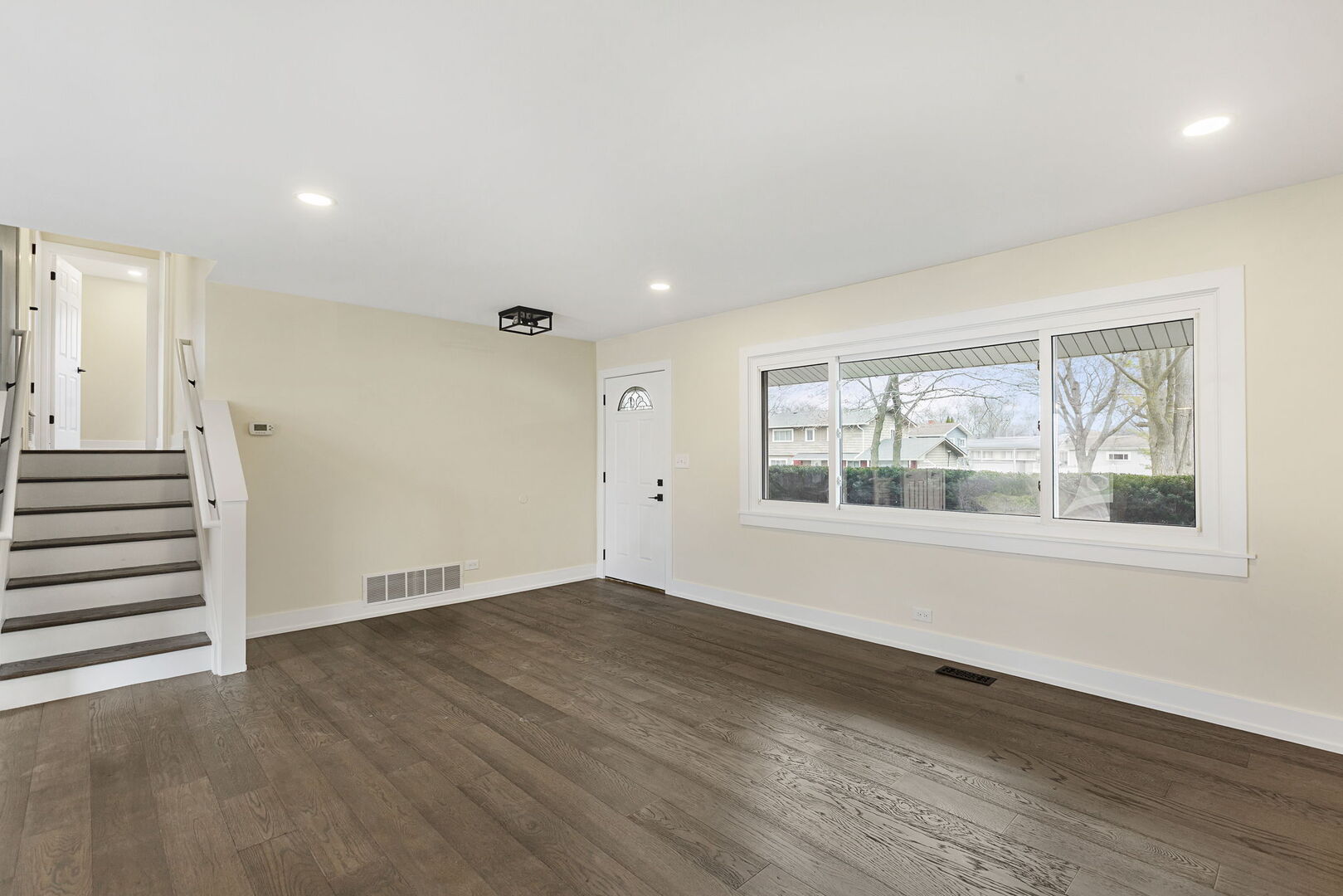 1910 Ashley Road Hoffman Estates, IL 60169 - Photo 4 of 30 an empty room with wooden floor and windows