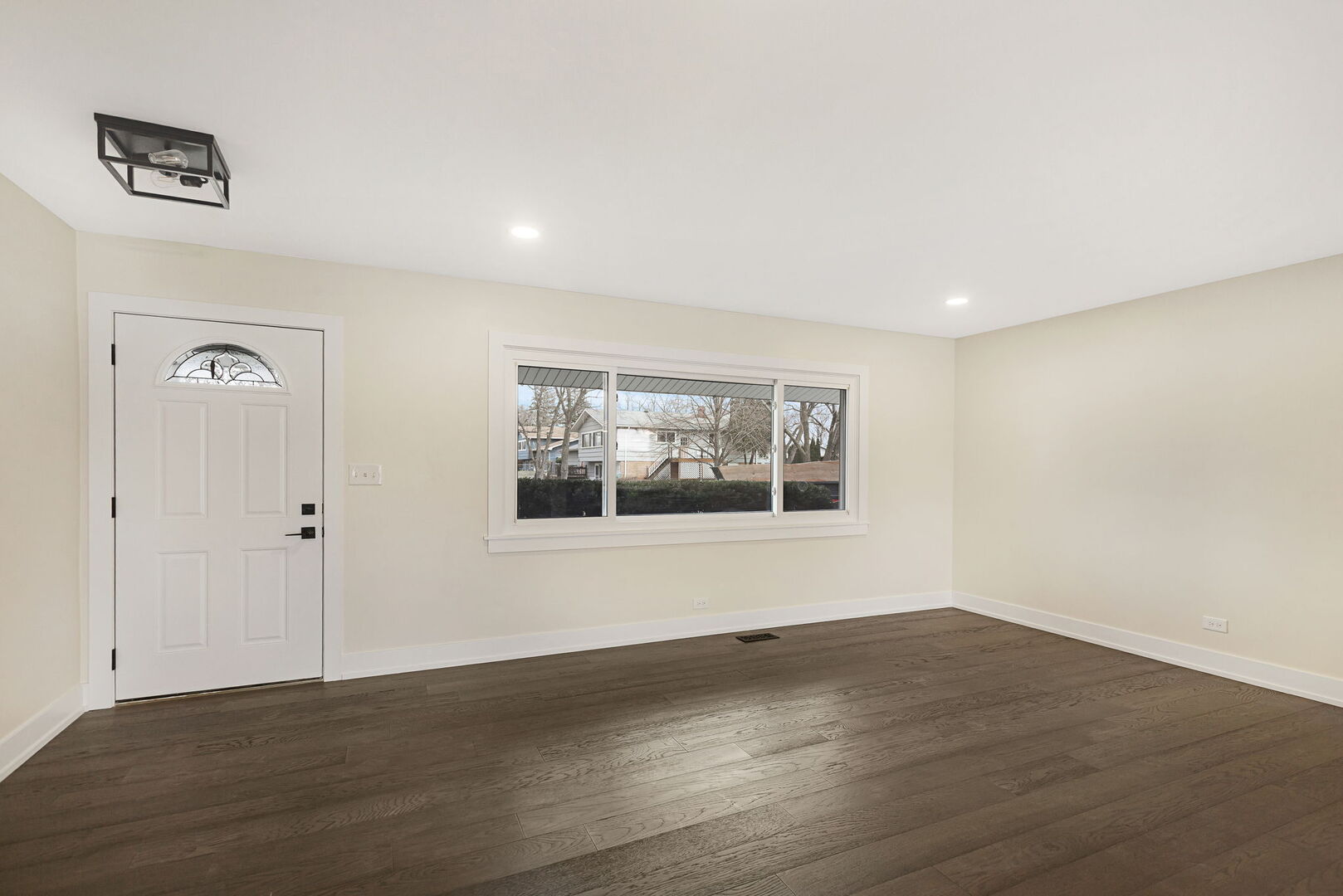 1910 Ashley Road Hoffman Estates, IL 60169 - Photo 6 of 30 a view of an empty room with wooden floor and a window