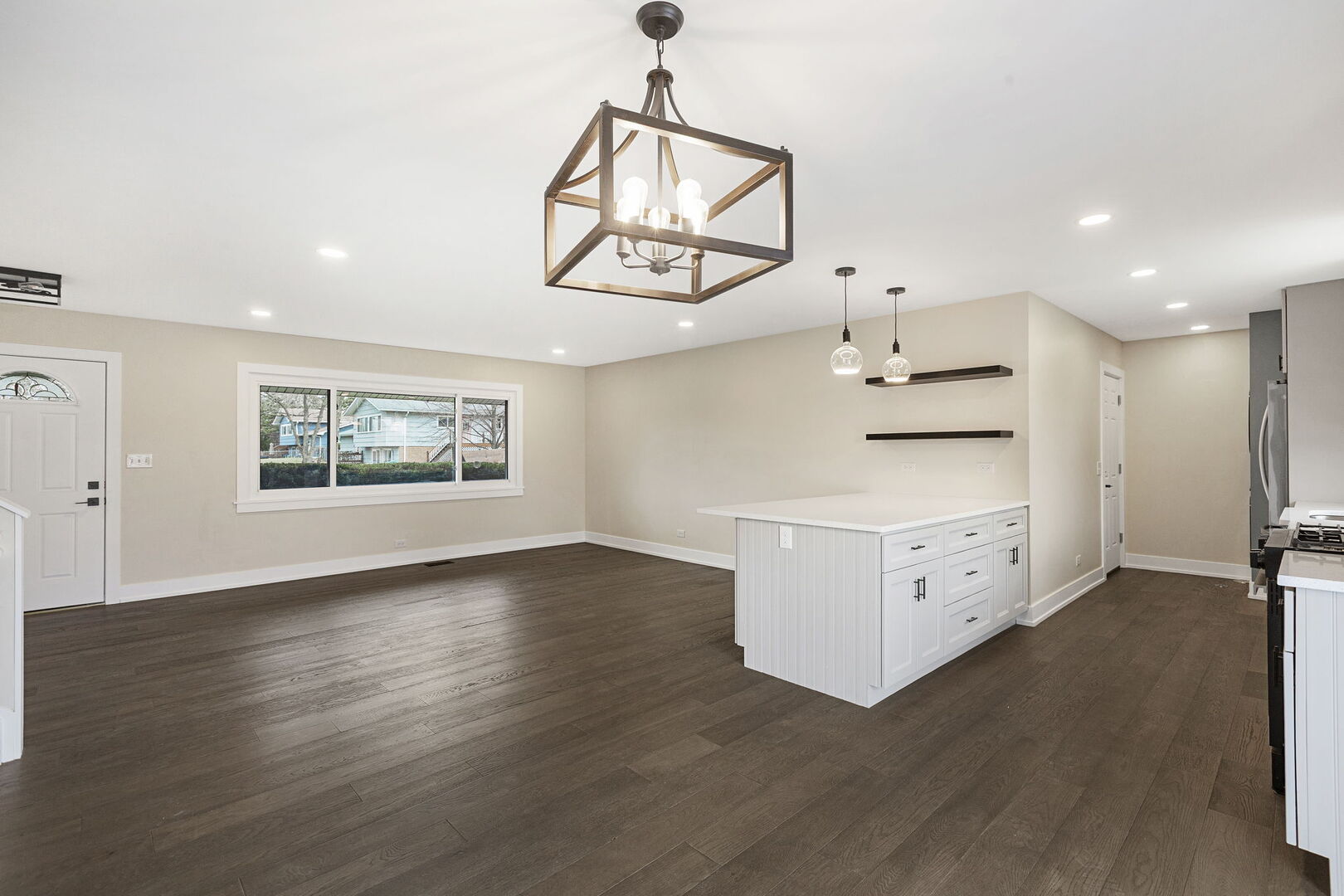 1910 Ashley Road Hoffman Estates, IL 60169 - Photo 7 of 30 an empty room with wooden floor ceiling fan and windows