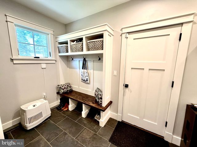 a view of a patio with couches and chairs under an umbrella